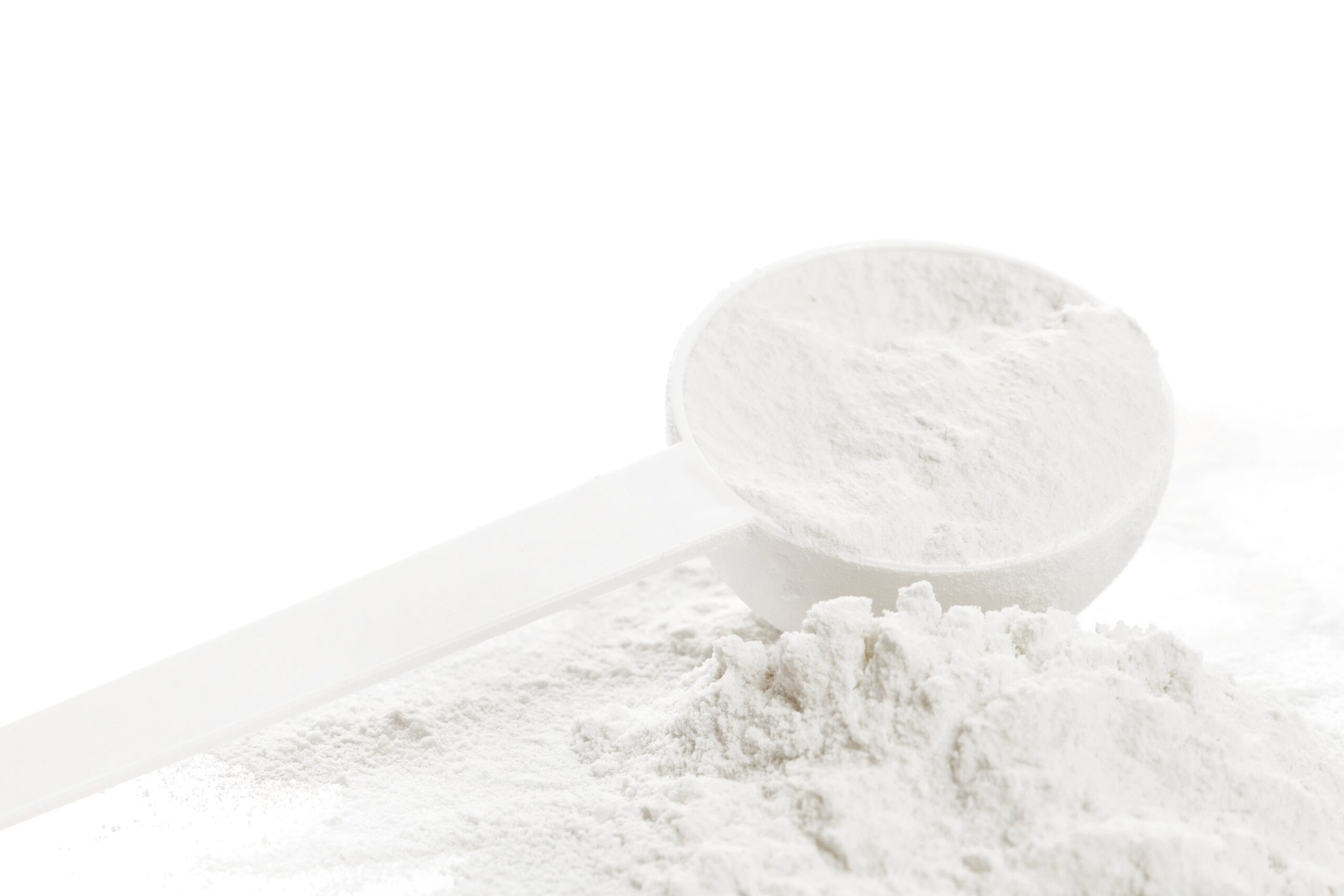 A closeup scoop of Creatine powder