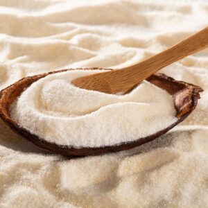 Hydrolyzed,Collagen,Or,Collagen,Peptides,Protein,Nutrient Collagen powder in a wooden dish, scooped by a wooden spoon.