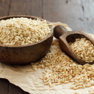 Pile,Of,Brown,Rice,In,A,Bowl,With,A,Wooden Brown Rice Protein